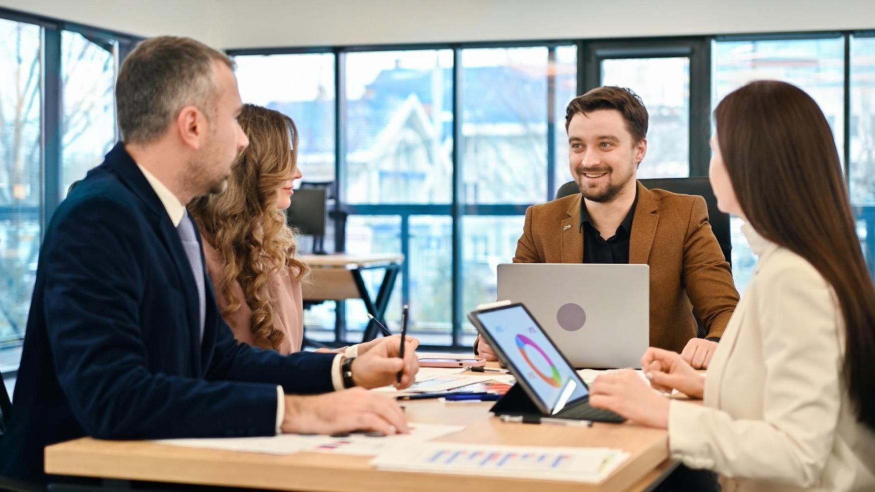 Group financial education workshop with participants reviewing materials
